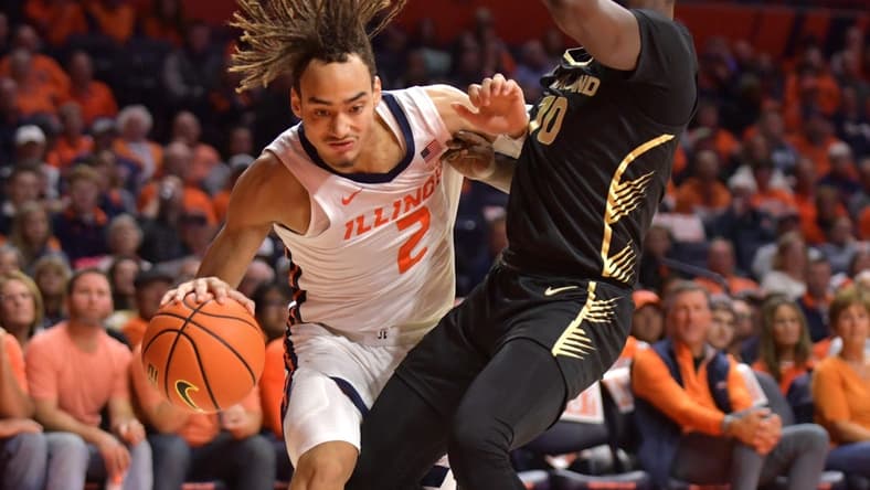 Nov 10, 2023; Champaign, Illinois, USA;  Illinois Fighting Illini guard Dra Gibbs-Lawhorn (2) drives against Oakland Golden Grizzlies guard DQ Cole (10) during the first half at State Farm Center. Mandatory Credit: Ron Johnson-USA TODAY Sports
