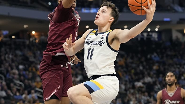 Nov 10, 2023; Milwaukee, Wisconsin, USA;  Marquette Golden Eagles guard Tyler Kolek (11) shoots against Rider Broncs forward Tariq Ingraham (33) during the first half at Fiserv Forum. Mandatory Credit: Jeff Hanisch-USA TODAY Sports