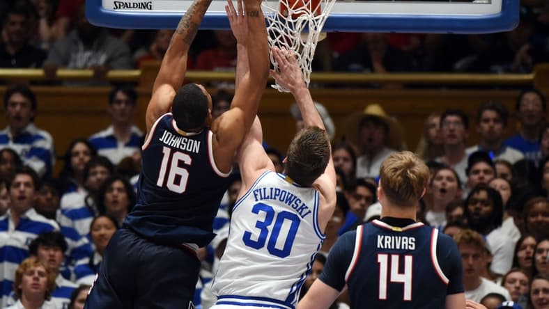 Nov 10, 2023; Durham, North Carolina, USA;  Arizona Wildcats forward Keshad Johnson (16) tips the ball into the basket in front of Duke Blue Devils center Kyle Filipowski(30)during the second half at Cameron Indoor Stadium. Mandatory Credit: Rob Kinnan-USA TODAY Sports