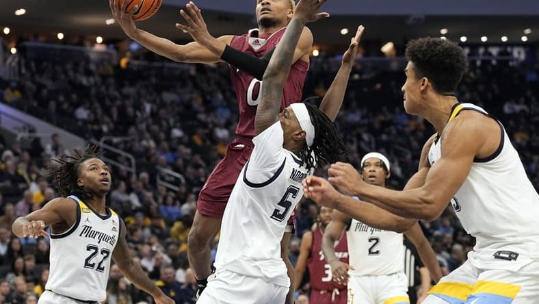 Nov 10, 2023; Milwaukee, Wisconsin, USA;  Rider Broncs guard D.J. Dudley (0) shoots against Marquette Golden Eagles guard Tre Norman (5) during the second half at Fiserv Forum. Mandatory Credit: Jeff Hanisch-USA TODAY Sports