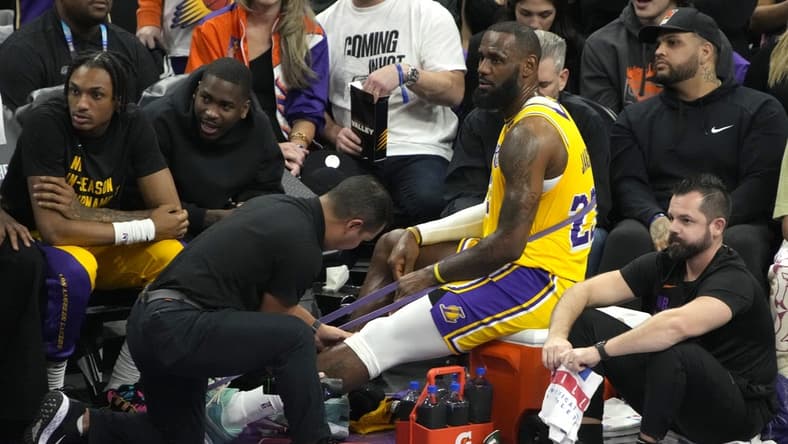 Nov 10, 2023; Phoenix, Arizona, USA; Los Angeles Lakers forward LeBron James (23) gets medical attention in a timeout against the Phoenix Suns in the first half at Footprint Center. Mandatory Credit: Rick Scuteri-USA TODAY Sports