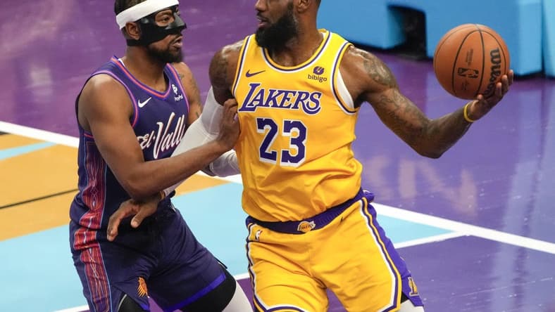 Nov 10, 2023; Phoenix, Arizona, USA; Los Angeles Lakers forward LeBron James (23) drives against Phoenix Suns guard Jordan Goodwin (0) in the first half at Footprint Center. Mandatory Credit: Rick Scuteri-USA TODAY Sports