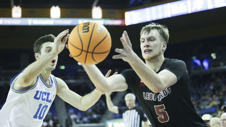 Nov 10, 2023; Los Angeles, California, USA; Lafayette guard Eric Sondberg (5) catches the ball as UCLA guard Lazar Stefanovic (10) defends in the second half at Pauley Pavilion presented by Wescom. Mandatory Credit: Yannick Peterhans-USA TODAY Sports