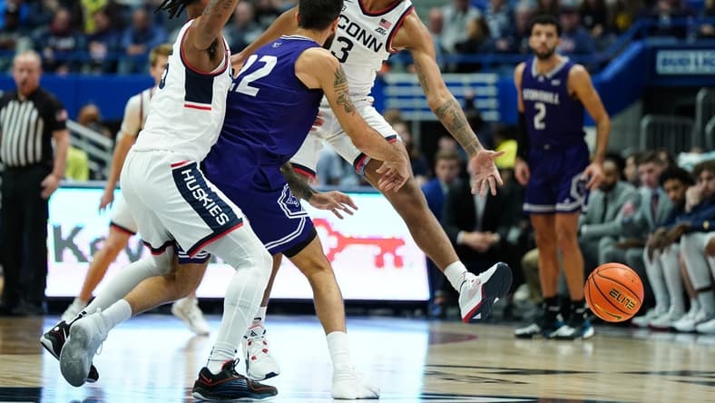 Nov 11, 2023; Hartford, Connecticut, USA; UConn Huskies forward Jaylin Stewart (3) and guard Stephon Castle (5) defend against Stonehill Skyhawks Pano Pavlidis (22) in the first half at XL Center. Mandatory Credit: David Butler II-USA TODAY Sports