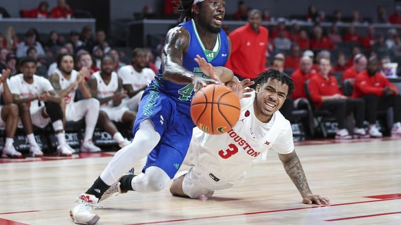 Nov 11, 2023; Houston, Texas, USA; Texas A&M-CC Islanders guard Lance-Amir Paul (40) drives with the ball as Houston Cougars guard Ramon Walker Jr. (3) defends during the first half at Fertitta Center. Mandatory Credit: Troy Taormina-USA TODAY Sports