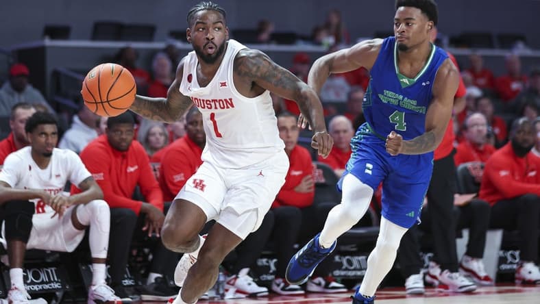 Nov 11, 2023; Houston, Texas, USA; Houston Cougars guard Jamal Shead (1) looks to pass the ball as Texas A&M-CC Islanders guard Kam Parker (4) defends during the second half at Fertitta Center. Mandatory Credit: Troy Taormina-USA TODAY Sports