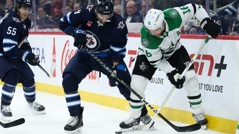 Nov 11, 2023; Winnipeg, Manitoba, CAN; Winnipeg Jets forward Alex Iafallo (9) battles Dallas Stars forward Joe Pavelski (16) for the puck during the second period at Canada Life Centre. Mandatory Credit: Terrence Lee-USA TODAY Sports