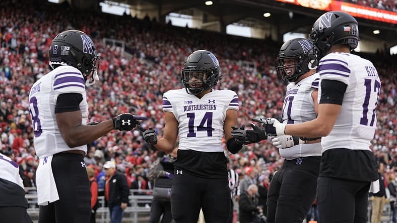 Nov 11, 2023; Madison, Wisconsin, USA;  Northwestern Wildcats wide receiver Cam Johnson (14) celebrates after scoring a touchdown during the second quarter against the Wisconsin Badgers at Camp Randall Stadium. Mandatory Credit: Jeff Hanisch-USA TODAY Sports