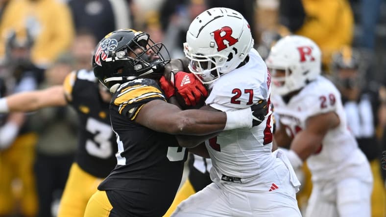 Nov 11, 2023; Iowa City, Iowa, USA; Iowa Hawkeyes linebacker Jay Higgins (34) tackles Rutgers Scarlet Knights running back Samuel Brown V (27) during the second quarter at Kinnick Stadium. Mandatory Credit: Jeffrey Becker-USA TODAY Sports