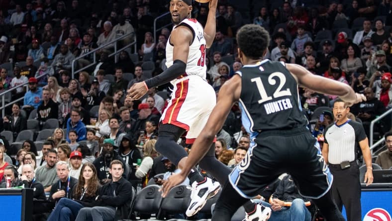 Nov 11, 2023; Atlanta, Georgia, USA; Miami Heat center Bam Adebayo (13) saves the ball from going out of bounds against Atlanta Hawks forward De'Andre Hunter (12) during the first quarter at State Farm Arena. Mandatory Credit: Jordan Godfree-USA TODAY Sports