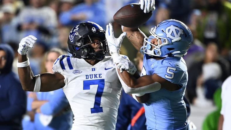 Nov 11, 2023; Chapel Hill, North Carolina, USA; North Carolina Tar Heels wide receiver J.J. Jones (5) catches the ball as Duke Blue Devils cornerback Al Blades Jr. (7) defends in the second quarter at Kenan Memorial Stadium. Mandatory Credit: Bob Donnan-USA TODAY Sports