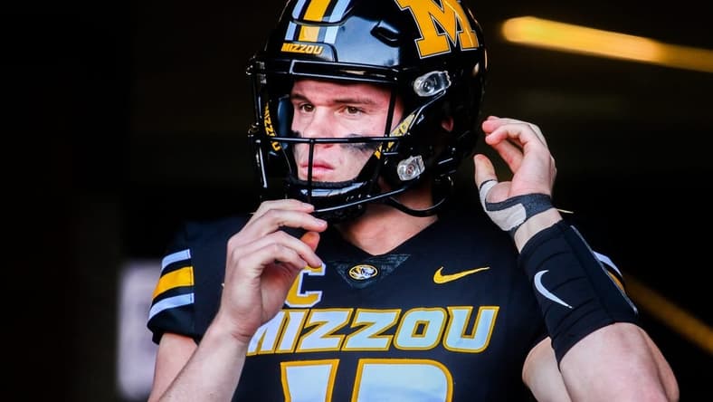 Missouri quarterback Brady Cook adjusts his helmet before a college football game at Faurot Field on Nov. 11, 2023, in Columbia, Mo.