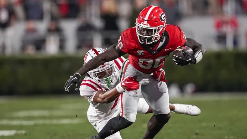 Nov 11, 2023; Athens, Georgia, USA; Georgia Bulldogs running back Daijun Edwards (30) runs against Mississippi Rebels cornerback Deantre Prince (7) during the first half at Sanford Stadium. Mandatory Credit: Dale Zanine-USA TODAY Sports