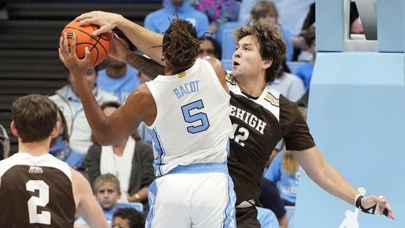 Nov 12, 2023; Chapel Hill, North Carolina, USA; Lehigh Mountain Hawks center JT Tan (42) blocks the shots of North Carolina Tar Heels forward Armando Bacot (5) in the first half at Dean E. Smith Center. Mandatory Credit: Bob Donnan-USA TODAY Sports