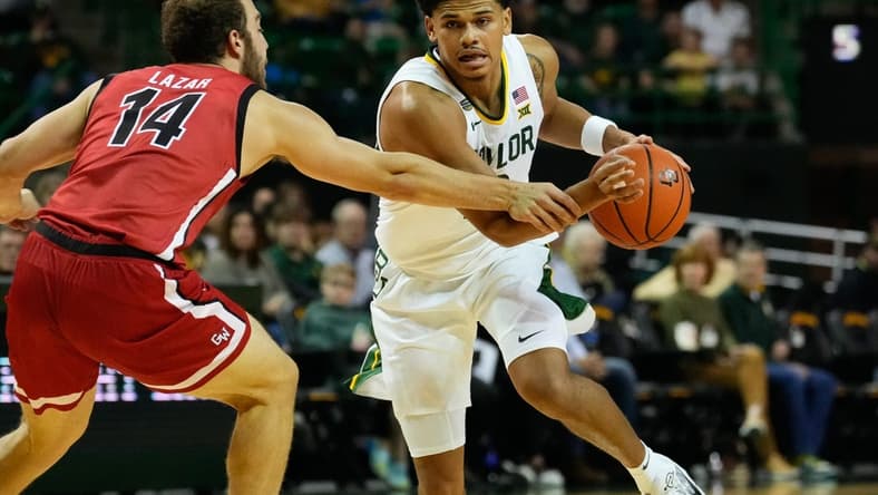Nov 12, 2023; Waco, Texas, USA;  Baylor Bears guard RayJ Dennis (10) controls the ball against Gardner Webb Runnin Bulldogs guard Shahar Lazar (14) during the first half at Ferrell Center. Mandatory Credit: Chris Jones-USA TODAY Sports