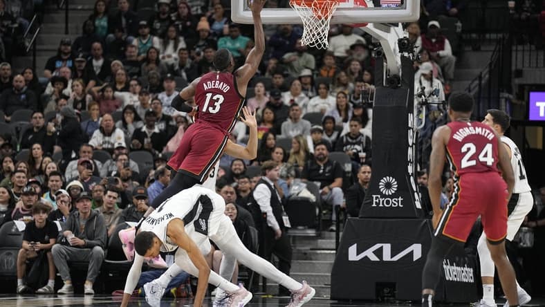 Nov 12, 2023; San Antonio, Texas, USA; Miami Heat center Bam Adebayo (13) drives to the basket past San Antonio Spurs forward Victor Wembanyama (1) during the first half at Frost Bank Center. Mandatory Credit: Scott Wachter-USA TODAY Sports