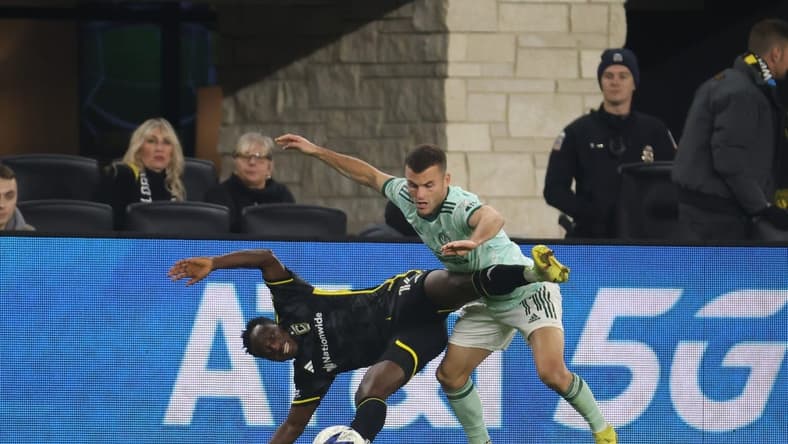 Nov 12, 2023; Columbus, Ohio, USA; Columbus Crew midfielder Yaw Yeboah (14) is challenged by Atlanta United FC defender Brooks Lennon (11) during the second half at Lower.com Field. Mandatory Credit: Trevor Ruszkowski-USA TODAY Sports