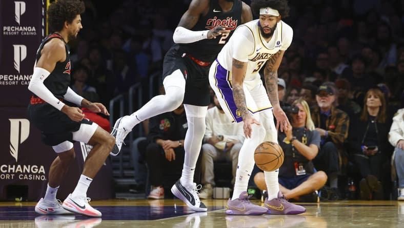 Nov 12, 2023; Los Angeles, California, USA; Los Angeles Lakers forward Anthony Davis (3) dribbles against Portland Trail Blazers center Deandre Ayton (2) during the first half of a game at Crypto.com Arena. Mandatory Credit: Jessica Alcheh-USA TODAY Sports