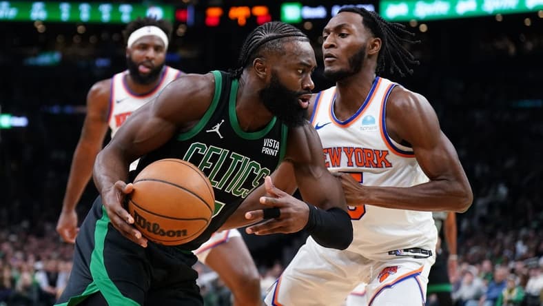 Nov 13, 2023; Boston, Massachusetts, USA; Boston Celtics guard Jaylen Brown (7) drives the ball against New York Knicks guard Immanuel Quickley (5) in the first quarter at TD Garden. Mandatory Credit: David Butler II-USA TODAY Sports