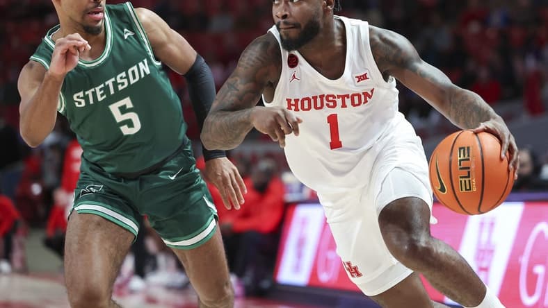 Nov 13, 2023; Houston, Texas, USA; Houston Cougars guard Jamal Shead (1) controls the ball as Stetson Hatters guard Jalen Blackmon (5) defends during the first half at Fertitta Center. Mandatory Credit: Troy Taormina-USA TODAY Sports