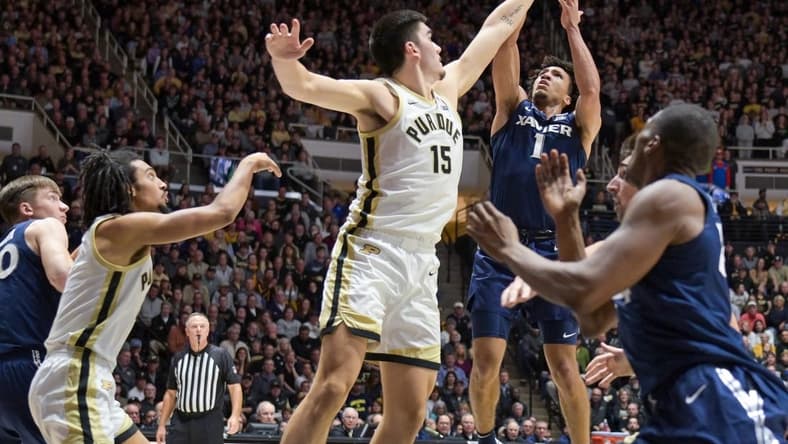 Nov 13, 2023; West Lafayette, Indiana, USA; Purdue Boilermakers center Zach Edey (15) blocks a shot by Xavier Musketeers guard Desmond Claude (1) during the first half at Mackey Arena. Mandatory Credit: Marc Lebryk-USA TODAY Sports