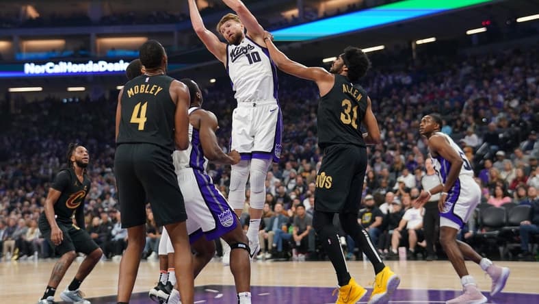 Nov 13, 2023; Sacramento, California, USA; Sacramento Kings forward Domantas Sabonis (10) grabs a rebound next to Cleveland Cavaliers center Jarrett Allen (31) in the first quarter at the Golden 1 Center. Mandatory Credit: Cary Edmondson-USA TODAY Sports