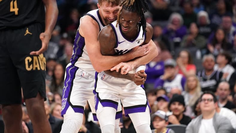 Nov 13, 2023; Sacramento, California, USA; Sacramento Kings forward Domantas Sabonis (10) hugs guard Keon Ellis (23) after Sabonis made a basket while being fouled against the Cleveland Cavaliers in the fourth quarter at the Golden 1 Center. Mandatory Credit: Cary Edmondson-USA TODAY Sports