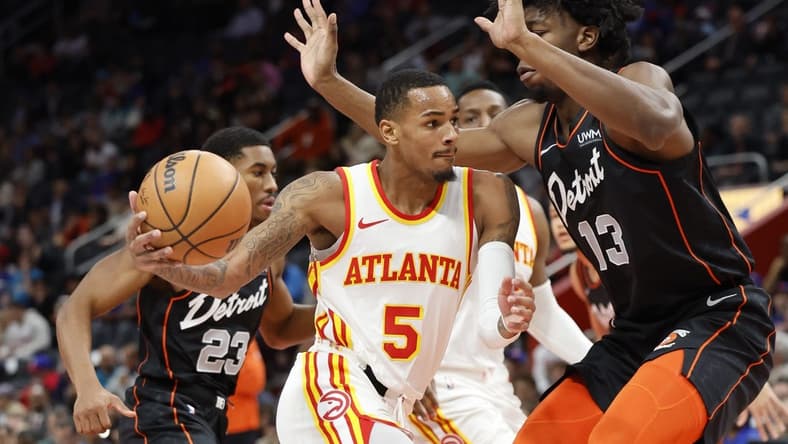 Nov 14, 2023; Detroit, Michigan, USA; Atlanta Hawks guard Dejounte Murray (5) dribbles defended by Detroit Pistons center James Wiseman (13) in the first half at Little Caesars Arena. Mandatory Credit: Rick Osentoski-USA TODAY Sports