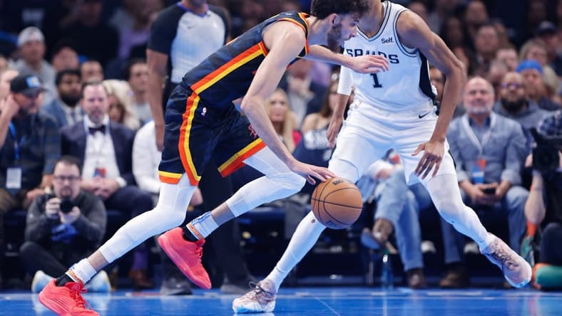 Nov 14, 2023; Oklahoma City, Oklahoma, USA; Oklahoma City Thunder forward Chet Holmgren (7) drives past San Antonio Spurs center Victor Wembanyama (1) during the second quarter at Paycom Center. Mandatory Credit: Alonzo Adams-USA TODAY Sports