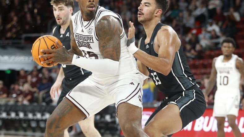 Nov 14, 2023; Starkville, Mississippi, USA; Mississippi State Bulldogs forward Jimmy Bell Jr. (15) spins toward the basket as North Alabama Lions forward Damian Forrest (33) defends during the first half at Humphrey Coliseum. Mandatory Credit: Petre Thomas-USA TODAY Sports