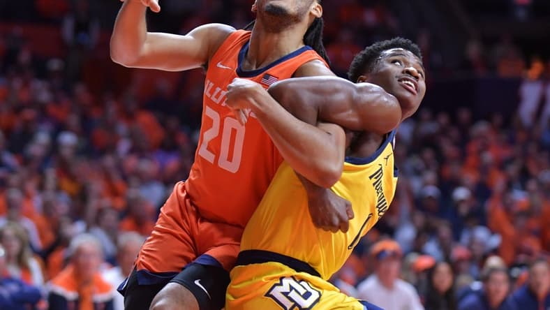 Nov 14, 2023; Champaign, Illinois, USA; Illinois Fighting Illini forward Ty Rodgers (20) and Marquette Golden Eagles guard Kam Jones (1) battle for position during the first half at State Farm Center. Mandatory Credit: Ron Johnson-USA TODAY Sports