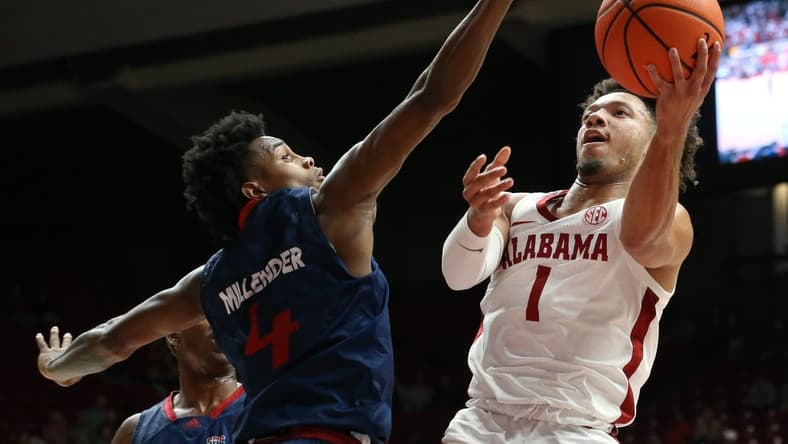 Nov 14, 2023; Tuscaloosa, Alabama, USA;  South Alabama guard Marcus Millender (4) guards a shot by Alabama guard Mark Sears (1) in the lane at Coleman Coliseum. Mandatory Credit: Gary Cosby Jr.-USA TODAY Sports