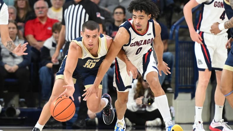 Nov 14, 2023; Spokane, Washington, USA; Gonzaga Bulldogs guard Ryan Nembhard (0) reaches in for the steal attempt against Eastern Oregon Mountaineers guard Malachi Afework (10) in the first half at McCarthey Athletic Center. Mandatory Credit: James Snook-USA TODAY Sports
