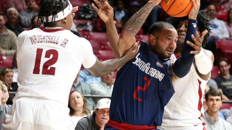 Nov 14, 2023; Tuscaloosa, Alabama, USA; South Alabama guard Isiah Gaiter (2) fights for the ball against Alabama guard Latrell Wrightsell Jr. (12) and guard Davin Cosby Jr. (4) during the second half Coleman Coliseum. Mandatory Credit: Gary Cosby Jr.-USA TODAY Sports