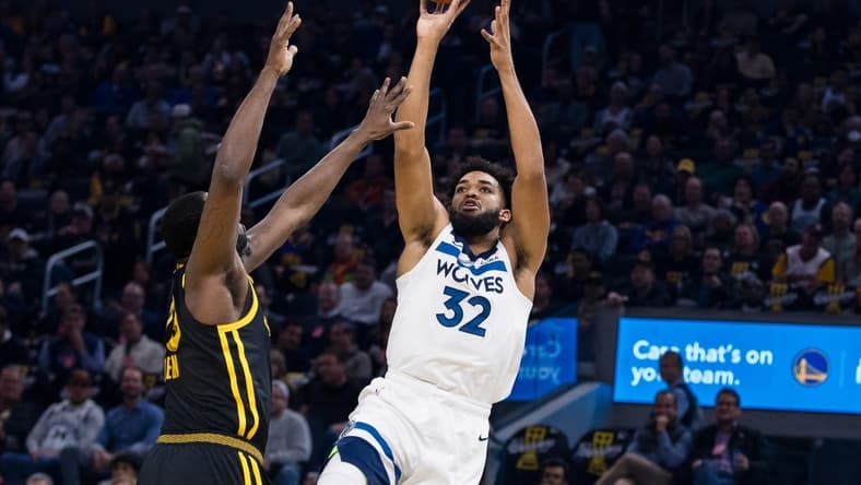 Nov 14, 2023; San Francisco, California, USA; Golden State Warriors forward Draymond Green (23) defends Minnesota Timberwolves forward Karl-Anthony Towns (32) during the first half at Chase Center. Mandatory Credit: John Hefti-USA TODAY Sports