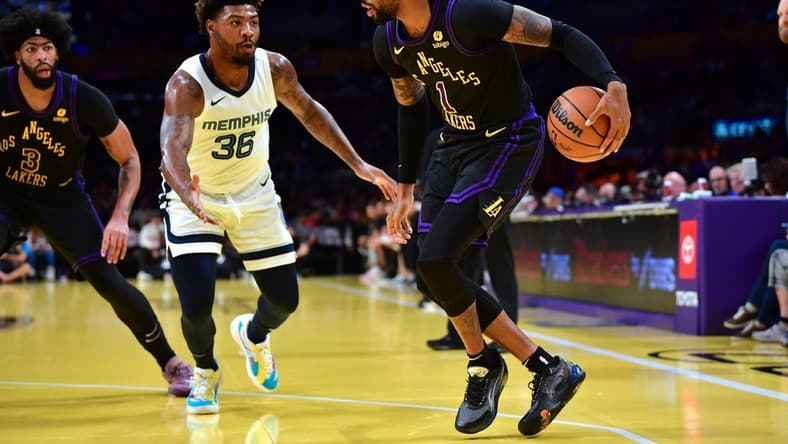 Nov 14, 2023; Los Angeles, California, USA; Los Angeles Lakers guard D Angelo Russell (1) moves the ball against Memphis Grizzlies guard Marcus Smart (36) during the first half at Crypto.com Arena. Mandatory Credit: Gary A. Vasquez-USA TODAY Sports