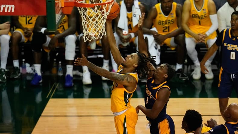 Nov 14, 2023; Waco, Texas, USA; Baylor Bears guard Jayden Nunn (2) scores a layup past UMKC Kangaroos guard Jayson Petty (1) during the second half at Ferrell Center. Mandatory Credit: Chris Jones-USA TODAY Sports