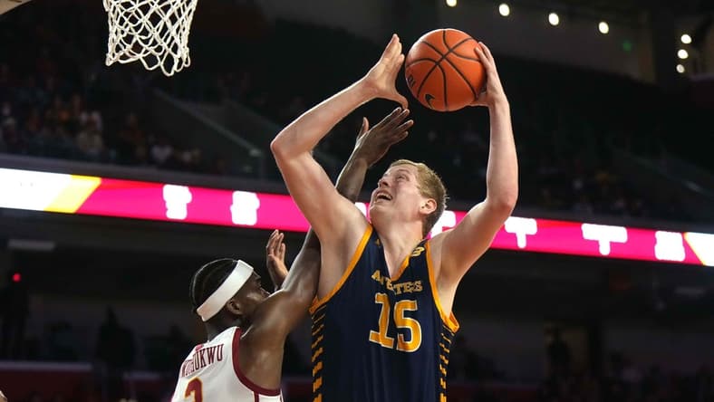 Nov 14, 2023; Los Angeles, California, USA; UC Irvine Anteaters center Bent Leuchten (15) shoots the ball against Southern California Trojans forward Vincent Iwuchukwu (3)  in the first half at Galen Center. Mandatory Credit: Kirby Lee-USA TODAY Sports