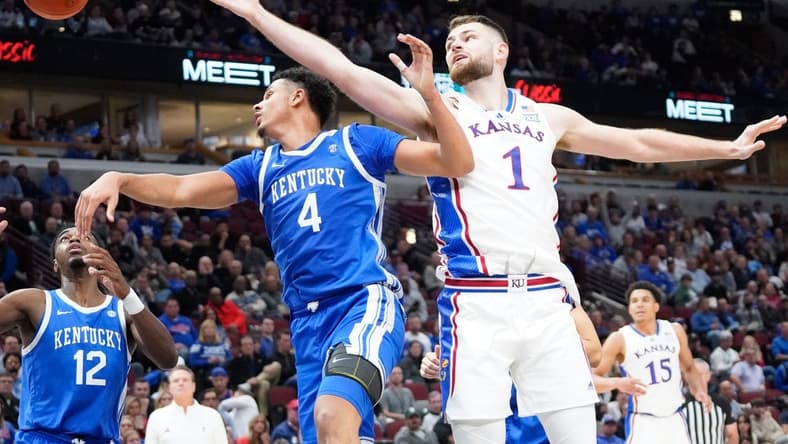 Nov 14, 2023; Chicago, Illinois, USA;  Kentucky Wildcats forward Tre Mitchell (4) defends Kansas Jayhawks center Hunter Dickinson (1) during the second half at United Center. Mandatory Credit: David Banks-USA TODAY Sports