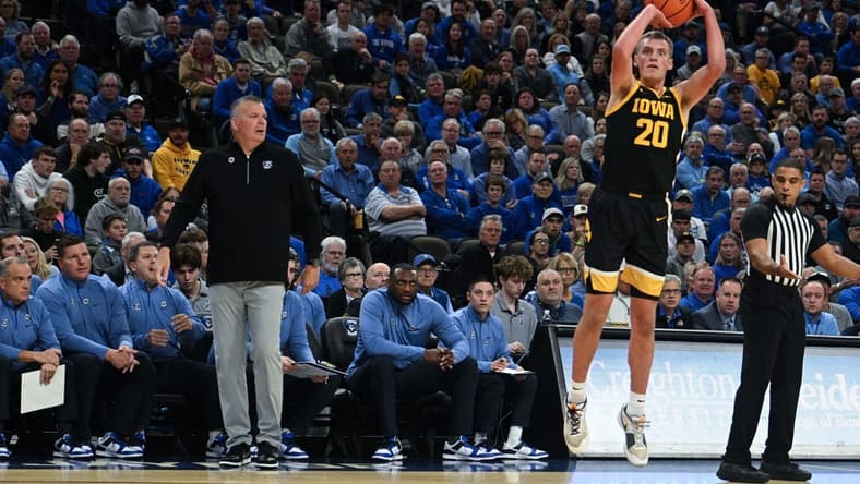 Nov 14, 2023; Omaha, Nebraska, USA; Iowa Hawkeyes forward Payton Sandfort (20) attempts a shot against the Creighton Bluejays in the first half at CHI Health Center Omaha. Mandatory Credit: Steven Branscombe-USA TODAY Sports