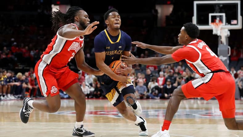 Nov 15, 2023; Columbus, Ohio, USA;  Merrimack College Warriors guard Jaylen Stinson (1) dribbles into the lane as Ohio State Buckeyes guard Bruce Thornton (left) and guard Dale Bonner (4) defend on the play at Value City Arena. Mandatory Credit: Joseph Maiorana-USA TODAY Sports