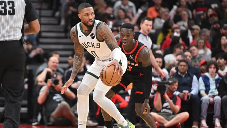 Nov 15, 2023; Toronto, Ontario, CAN;  Milwaukee Bucks guard Damian Lillard (0) controls the ball as Toronto Raptors guard Dennis Schroder (17) defends in the first half at Scotiabank Arena. Mandatory Credit: Dan Hamilton-USA TODAY Sports