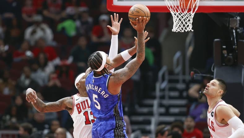 Nov 15, 2023; Chicago, Illinois, USA; Orlando Magic forward Paolo Banchero (5) shoots against Chicago Bulls forward Torrey Craig (13) during the first half at United Center. Mandatory Credit: Kamil Krzaczynski-USA TODAY Sports