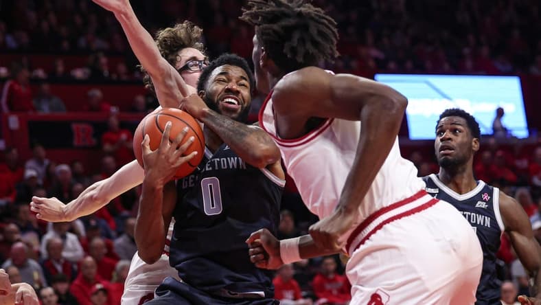 Nov 15, 2023; Piscataway, New Jersey, USA; Georgetown Hoyas guard Dontrez Styles (0) drives to the basket against Rutgers Scarlet Knights guard Gavin Griffiths (10) and forward Antwone Woolfolk (13) during the first half at Jersey Mike's Arena. Mandatory Credit: Vincent Carchietta-USA TODAY Sports