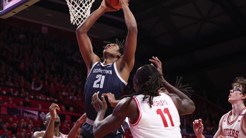 Nov 15, 2023; Piscataway, New Jersey, USA; Georgetown Hoyas center Ryan Mutombo (21) goes to the basket in front of Rutgers Scarlet Knights center Clifford Omoruyi (11) and guard Gavin Griffiths (10) during the first half at Jersey Mike's Arena. Mandatory Credit: Vincent Carchietta-USA TODAY Sports