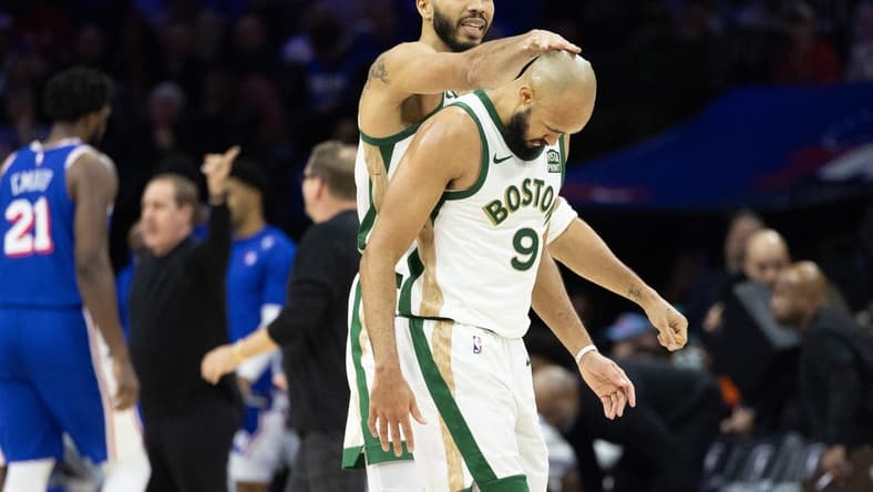 Nov 15, 2023; Philadelphia, Pennsylvania, USA; Boston Celtics forward Jayson Tatum (0) congratulates guard Derrick White (9) after his three pointer against the Philadelphia 76ers during the fourth quarter at Wells Fargo Center. Mandatory Credit: Bill Streicher-USA TODAY Sports
