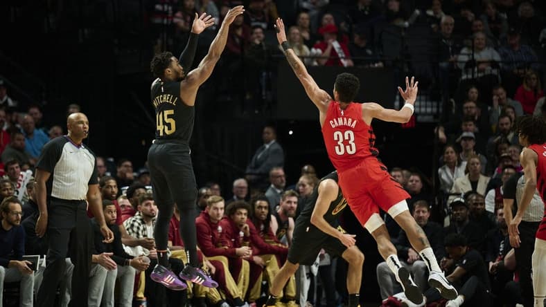 Nov 15, 2023; Portland, Oregon, USA; Cleveland Cavaliers guard Donovan Mitchell (45) shoots a basket during the first half against Portland Trail Blazers forward Toumani Camara (33) at Moda Center. Mandatory Credit: Troy Wayrynen-USA TODAY Sports