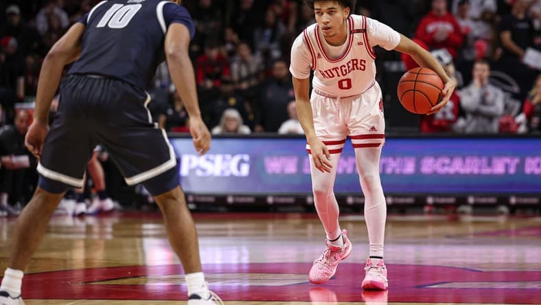 Nov 15, 2023; Piscataway, New Jersey, USA; Rutgers Scarlet Knights guard Derek Simpson (0) dribbles as Georgetown Hoyas guard Jayden Epps (10) defends during the second half at Jersey Mike's Arena. Mandatory Credit: Vincent Carchietta-USA TODAY Sports