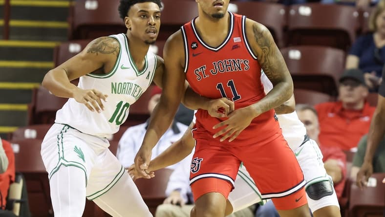 Nov 16, 2023; Charleston, South Carolina, USA; St. John's Red Storm center Joel Soriano (11) is defended by North Texas Mean Green forward Robert Allen (10) in the first half at TD Arena. Mandatory Credit: David Yeazell-USA TODAY Sports