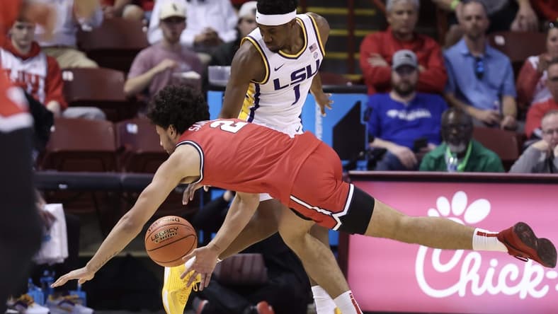 Nov 16, 2023; Charleston, South Carolina, USA;  LSU Tigers guard Carlos Stewart (1) and Dayton Flyers forward Nate Santos (2) scramble for a ball in the first half at TD Arena. Mandatory Credit: David Yeazell-USA TODAY Sports